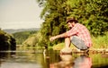 fly fish hobby. Summer activity. mature bearded man with fish on rod. hipster fishing with spoon-bait. The Old Man and Royalty Free Stock Photo