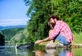 Fly fish hobby. Summer activity. successful fisherman in lake water. big game fishing. relax on nature. mature bearded Royalty Free Stock Photo