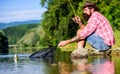 Fly fish hobby. Summer activity. successful fisherman in lake water. hipster fishing with spoon-bait. big game fishing Royalty Free Stock Photo