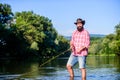 Fly fish hobby. Summer fishery activity. hipster fishing with spoon-bait. big game fishing. relax on nature. successful Royalty Free Stock Photo