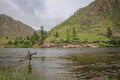 Fly fisherman casting a fly on a river in Mongolia during the summer, Moron, Mongolia Royalty Free Stock Photo