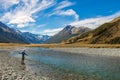 A fly fisherman casting for trout on the Ahuriri River in New Zealand Royalty Free Stock Photo