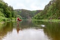 Fly fisherman catching a trout. Outdoor fishing in river. Fisherman fishing equipment