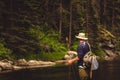 A fly fisherman fishing for trout on the mountain river in Northern Idaho Royalty Free Stock Photo