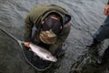 Fly fisherman holding rainbow trout Royalty Free Stock Photo