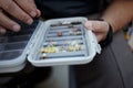 Fly fisherman selecting a specific fly from a box Royalty Free Stock Photo