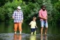 Fly fisherman using fly fishing rod in river. Happy people family have fishing and fun together. Senior man fishing with