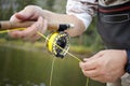 Fly fisherman using a spinning reel