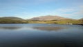 Fly fishing from a boat on Llyn Dywarchen with Yr Wyddfa in the background