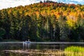 Fly fishing from drift boat in autumn, on a calm river