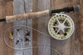 Fly fishing gear and tackle on weathered wood. Royalty Free Stock Photo