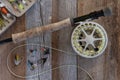 Fly fishing gear and tackle on weathered wood. Royalty Free Stock Photo