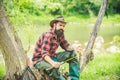 Fly fishing in the pristine wilderness of Canada. Happy fisherman fishing in river holding fishing rods.