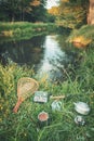 Fly fishing rod and box with flies on the river bank Royalty Free Stock Photo