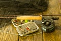 Fly fishing rod ,flie and a landing net on the old wooden table. All ready for fishing. Royalty Free Stock Photo