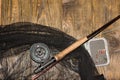 Fly fishing rod ,flie and a landing net on the old wooden table. All ready for fishing. Royalty Free Stock Photo