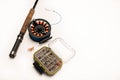 Fly fishing rod, reel, and flies on a white background Royalty Free Stock Photo