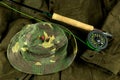 Fly Fishing Rod and Reel with Line on an Outdoor Coat with Fishing Hat and Trout Flies Royalty Free Stock Photo