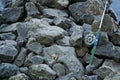 Fly fishing rod and reel on stone river bank. Fishing scene on the banks Royalty Free Stock Photo