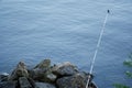 Fly fishing rod and reel on stone river bank. Fishing scene on the banks Royalty Free Stock Photo