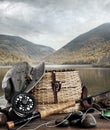 Fly rod with creel and equipment on wood