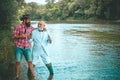 Fly rod and reel with a brown trout from a stream. Brown trout fish. Grandfather and boy fishing together. Fly fishing Royalty Free Stock Photo