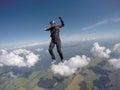 Extreme. Man with parachute flies in the blue sky. Free fall. Skydiving sports. Royalty Free Stock Photo