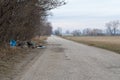 Fly tipped rubbish dumped in a lay-by in a country lane. Heap of illegally dumped household rubbish left on a side of the road Royalty Free Stock Photo