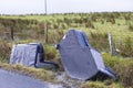 Fly tipping of furniture sofa chairs at roadside in rural area causing countryside pollution