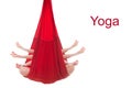Fly yoga. A girl sits in the lotus position in a red hammock for aerial yoga doing mudras on a white background. Shiva`s hands. Royalty Free Stock Photo