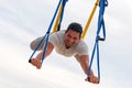 Fly Yoga, man doing yoga exercises on the sky background. Sport and healthy concept Royalty Free Stock Photo