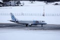 FlyBe jet taxiing in Innsbruck Airport, INN, snow Royalty Free Stock Photo