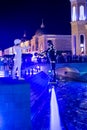 Flyboard riders in the swimming pool at night in the shopping avenue of the Land of legends complex