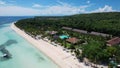 Flyby of Bohol Beach Club in Dumaluan Beach, Panglao Island in Bohol Province. Daytime aerial of a popular resort in the