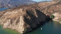 Flyby footage of a boat cruising emerald waters of Castaic lake near Los Angeles on a beautiful sunny day, 4k aerial