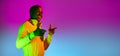 Flyer. Portrait of young African handsome man posing isolated over studio background in gradient neon light