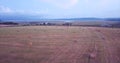 Flying above and aerial view of a field with hay stacks. Rural scene. Russia