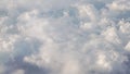 Flying above the clouds in daytime view form airplane window Royalty Free Stock Photo