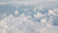 Flying above the clouds in daytime view form airplane window Royalty Free Stock Photo