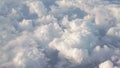 Flying above the clouds in daytime view form airplane window Royalty Free Stock Photo