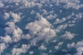 Flying above the earth and above the clouds in the territory of Singapore. Airplane window view. The plane flies in sky above the Royalty Free Stock Photo