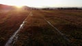 Flying above flooded autumn fields at sunset.