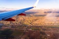 Flying above Santa Clara county close to sunset, Highway 101 visible at the base of the hills; agricultural fields visible in the