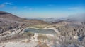 Flying above snowy winter misty mountain forest covered with snow Royalty Free Stock Photo