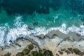 Flying above turquoise ocean waves, top down view