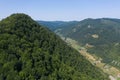 Flying above a valley and deciduous forest. Aerial shot by drone. Iada valley, Apuseni mountains, Romania Royalty Free Stock Photo