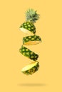 Flying in air fresh ripe Pineapple slices isolated on pastel yellow Royalty Free Stock Photo