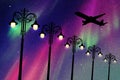 Flying aircraft and vintage lampposts at night Royalty Free Stock Photo