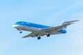 Flying Airplane KLM Cityhopper PH-KZI Fokker F70 is landing at Schiphol airport. Royalty Free Stock Photo
