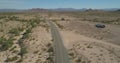 Aerial view of desert road with mountains in the background